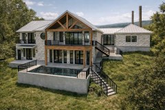 Rear elevation view of a Hill Country home with stone exterior, wood gable framing, pool deck, and black railings.